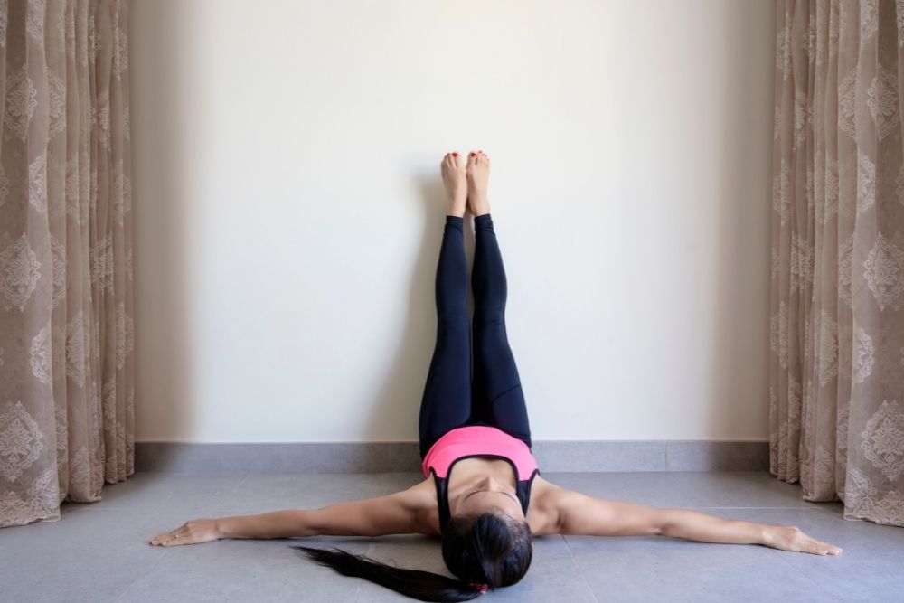 woman doing legs on the wall yoga stretch