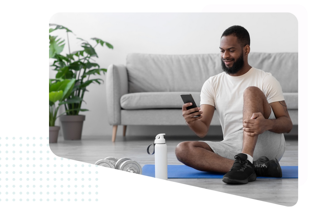 Man working out on mobile device at home